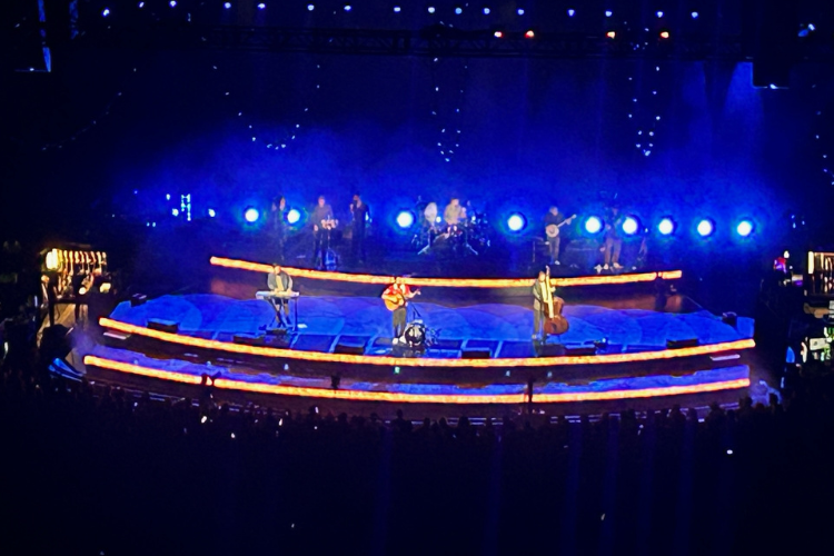 Mumford-and-Sons-Bell-Centre-Montreal - The lighting met the mood of the music during the Mumford & Sons concert at the Bell Centre in Montreal. The band, and all their featured artists, used every bit of stage and engaged the audience with their talents for a show over two-hours long.