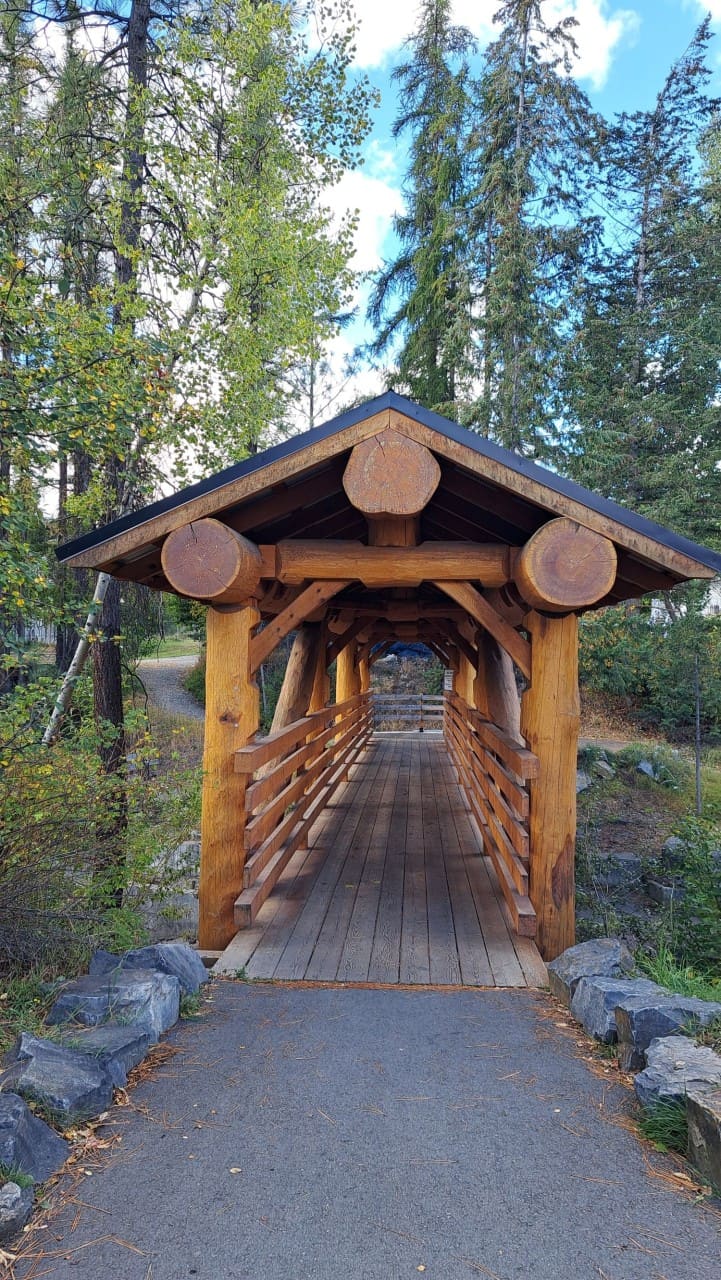 Handcrafted Wooden Footbridge Leading to Marysville Falls BC - This bridge shows the craftsmanship Kimberley is known for. Built by Tyee Homes, it reflects the community’s support for using local wood in public structures.