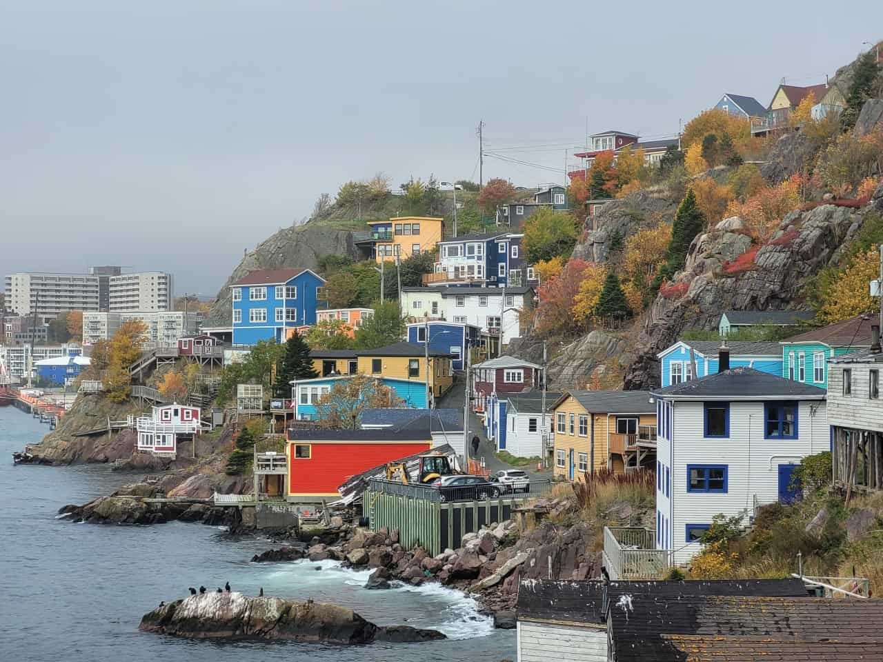 Scenic View of The Battery’s Colourful Houses from St. John's' North Head Trail - Take in the stunning view of The Battery's colourful houses from the North Head Trail, St. John's, NL. This scene offers a glimpse of this iconic St. John's neighbourhood against the backdrop of rugged coastline.