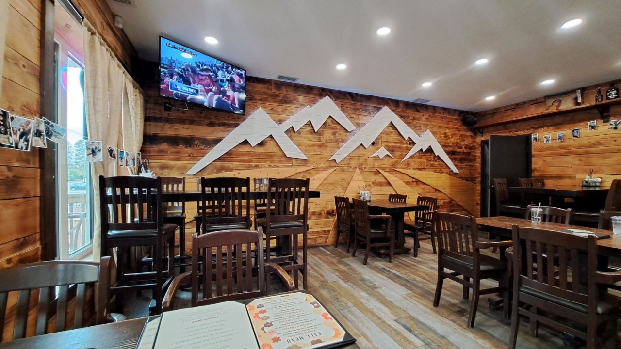 Interior of Dark Woods Taproom – Mountain Meets Western Design in Innisfail - Warm wood, alpine lodge energy, and a space that feels equally at home after a mountain hike or a prairie road trip.
