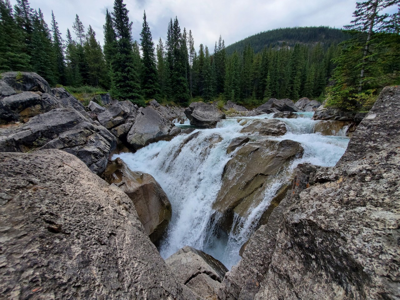 Powerful Cascade at Hummingbird Falls - Fast-moving turquoise water crashes through giant rock formations at Hummingbird Falls in Alberta.