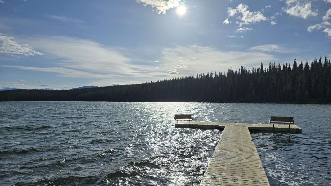 Shunda Lake Alberta Canada  - Afternoon sunshine sparkles across the water from the dock at Fish Lake Recreation Area in David Thompson Country