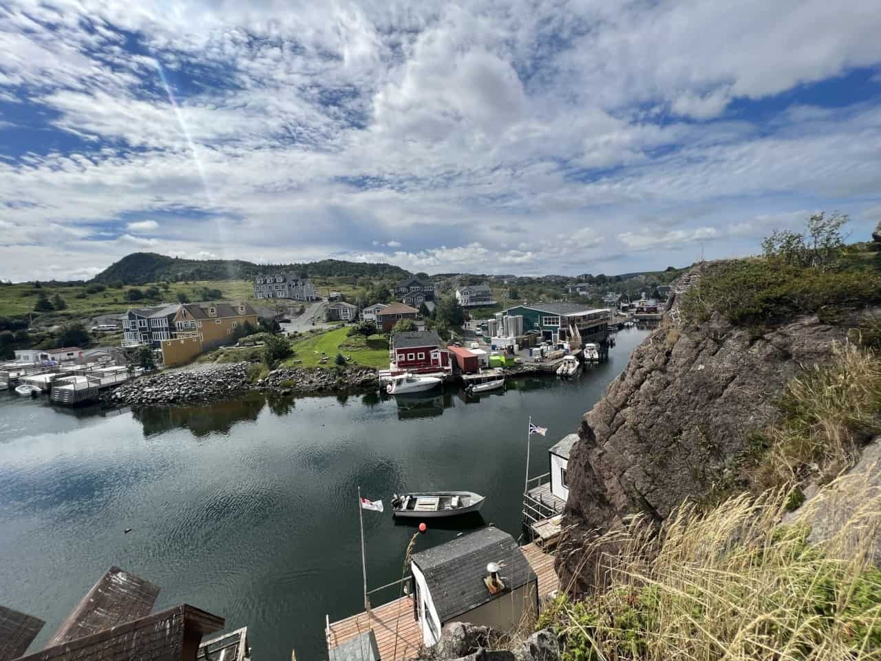 Quidi Vidi Village near Sugar Loaf Path on the East Coast Trail Newfoundland - The view from the trail overlooking Quidi Vidi Village shows local fishing huts that are still being used, local homes and the Quidi Vidi Brewery. The brewery is a great location for a refreshing drink at the end of the long hike. In the summertime there are also various food trucks and a beer tent on The Wharf. 