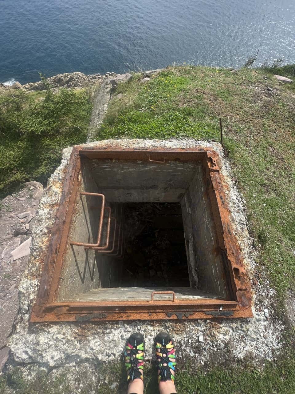 World War II Observation Station in St. John's on the East Coast Trail and Sugar Loaf Path - The observation station looks out over the cliff, but the entryway from above, that you see here, is how you get into the station when visiting this St. John's attraction.