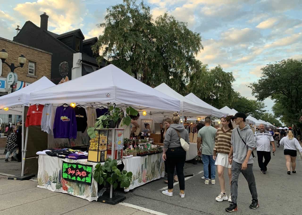 Vendor Booths at Super Crawl In Hamilton Ontario - White, square tents filled with local artist's work, line James Street North in Hamilton, Ontario Canada. Visitors can wander the street to browse and purchase a variety of  different crafts and goods.